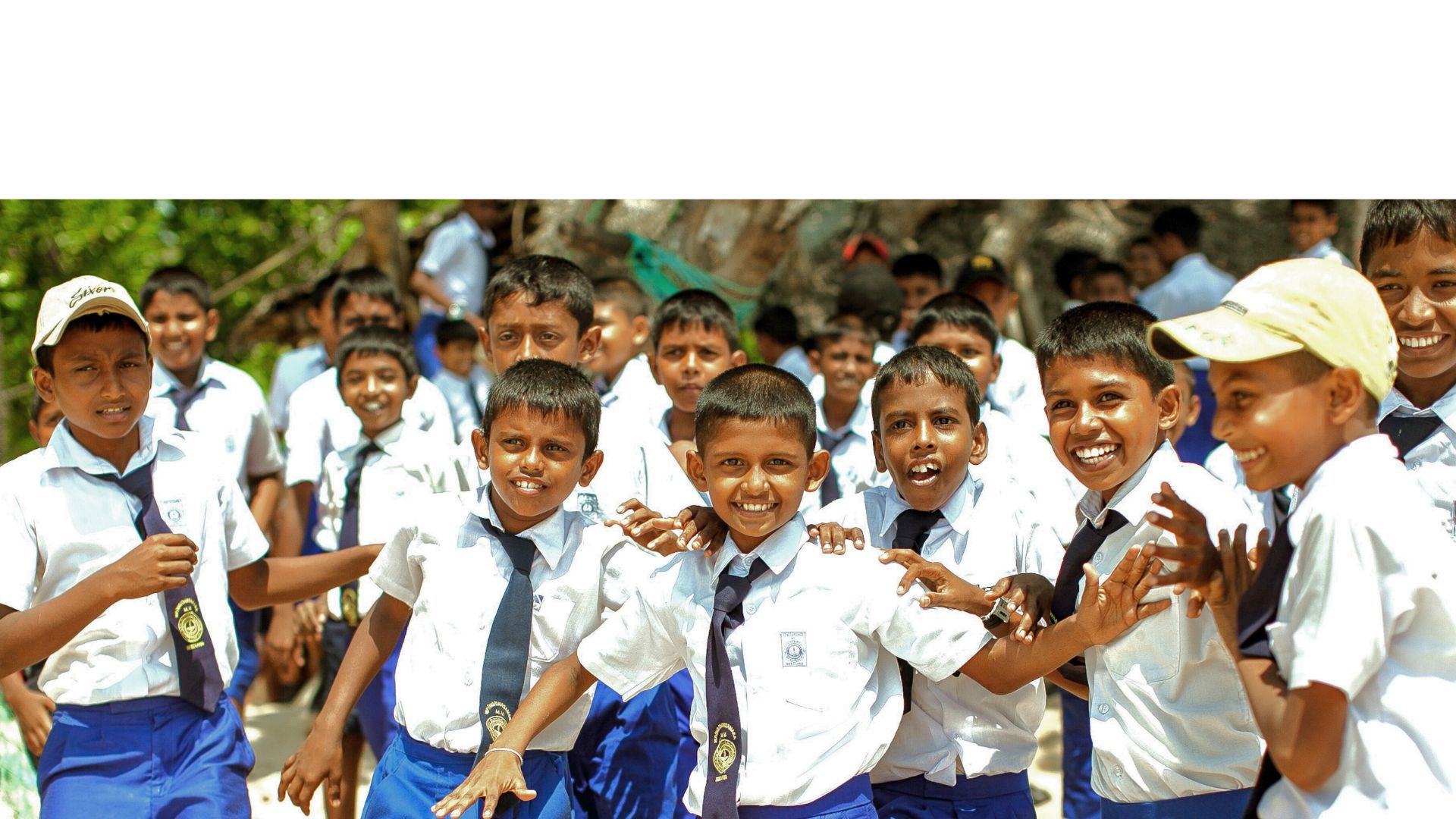 Group of smiling young people standing in front of a building with wooden paneling